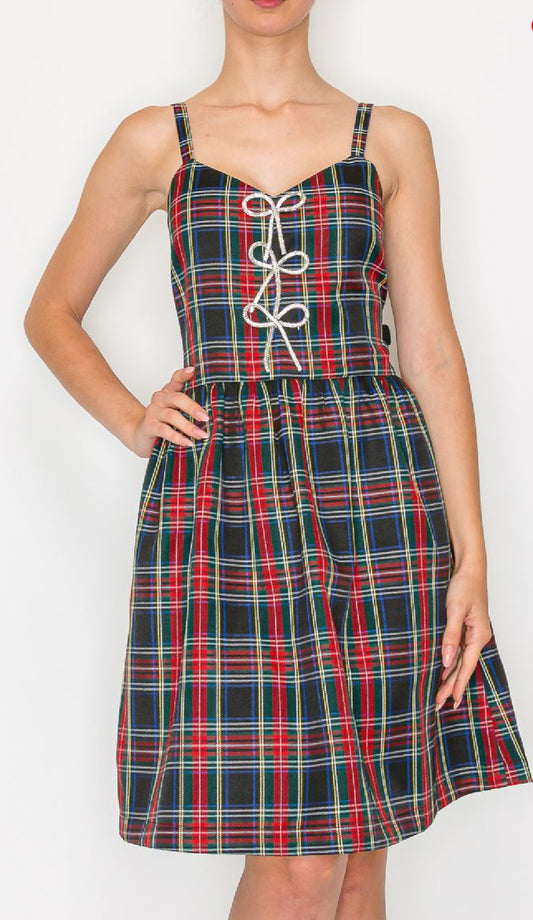 Holiday plaid camis dress with rhinestone ribbon at front.